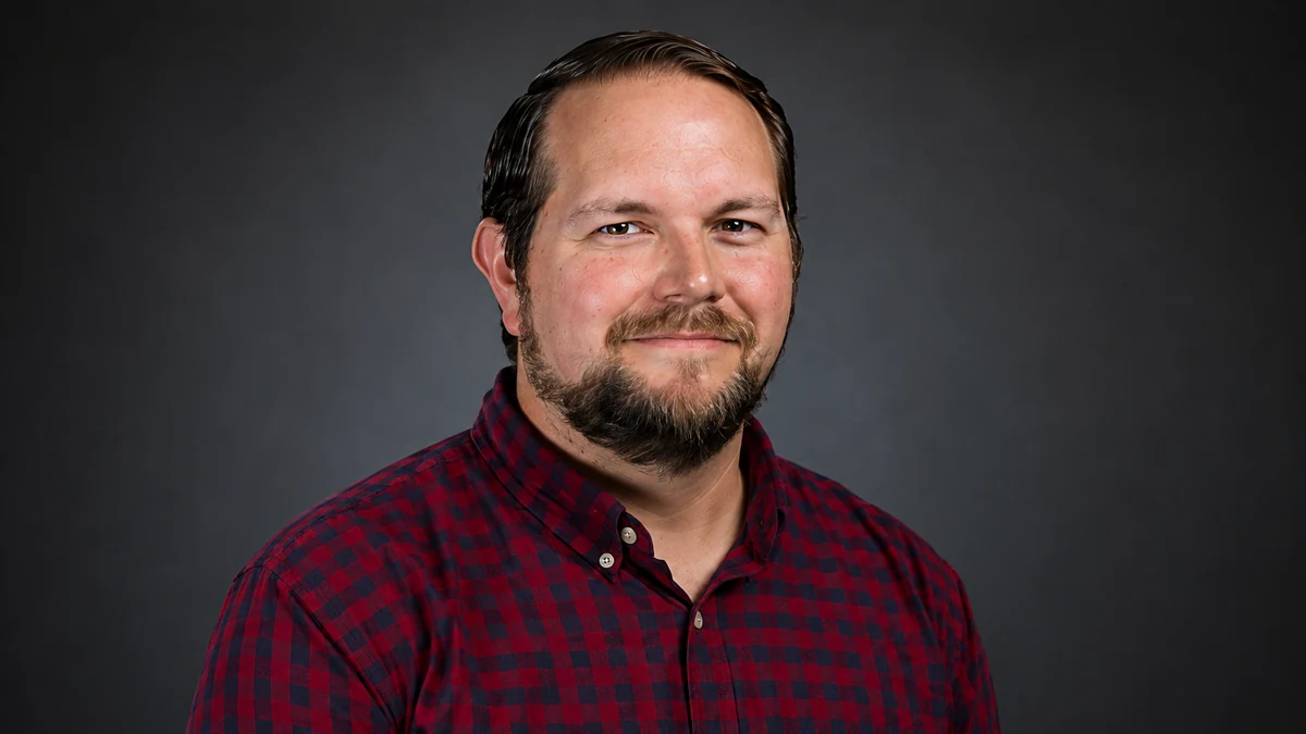 Professional client headshot photographed against green screen and finished against a neutral studio background